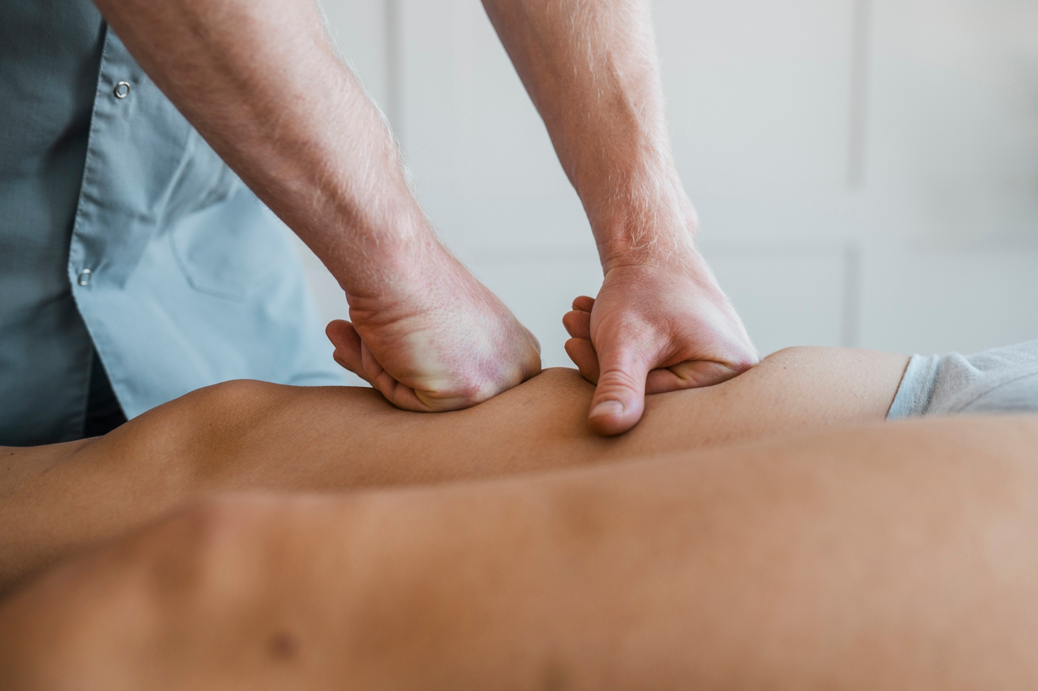 male-physiotherapist-on-massage-session-with-female-patient