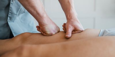 male-physiotherapist-on-massage-session-with-female-patient