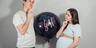young parents with a balloon to find out the gender of the baby, closeup